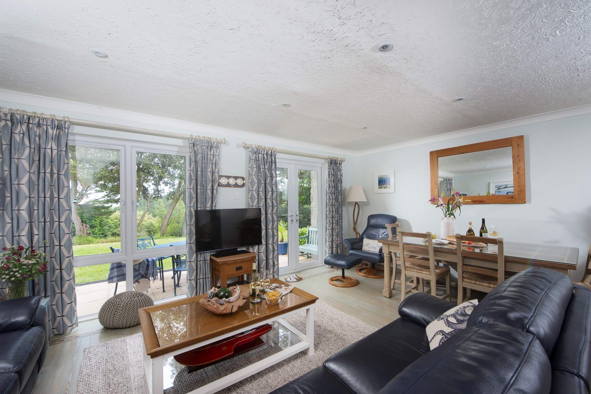 Large windows over look the patio and gardens with their beautiful planting. 