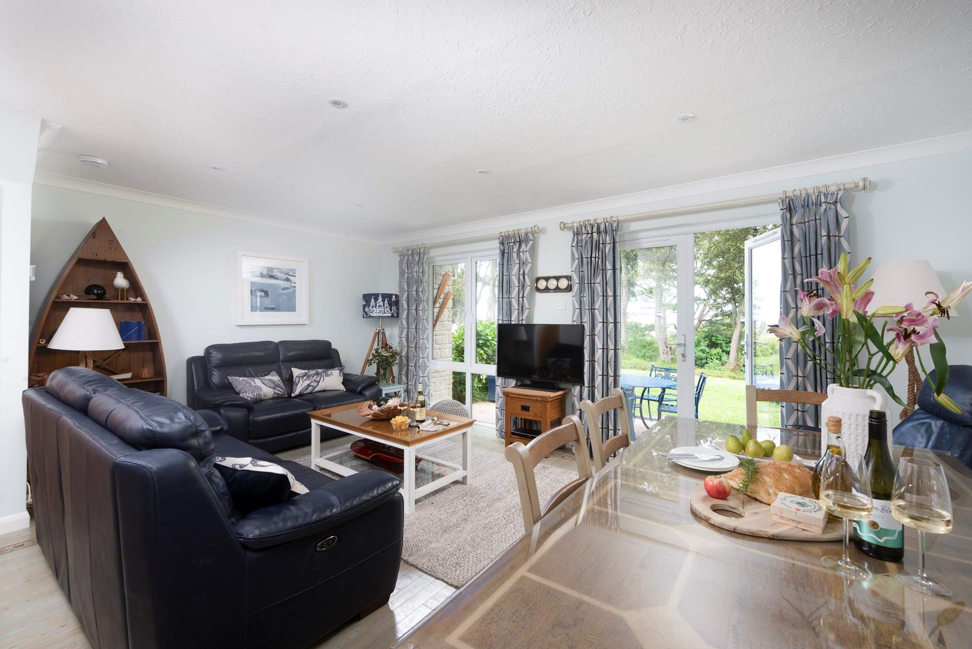 The open plan living space looks out over the patio, communal gardens and out to sea. 