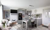 The open plan living space is adorned with grey tones. - Thumbnail Image