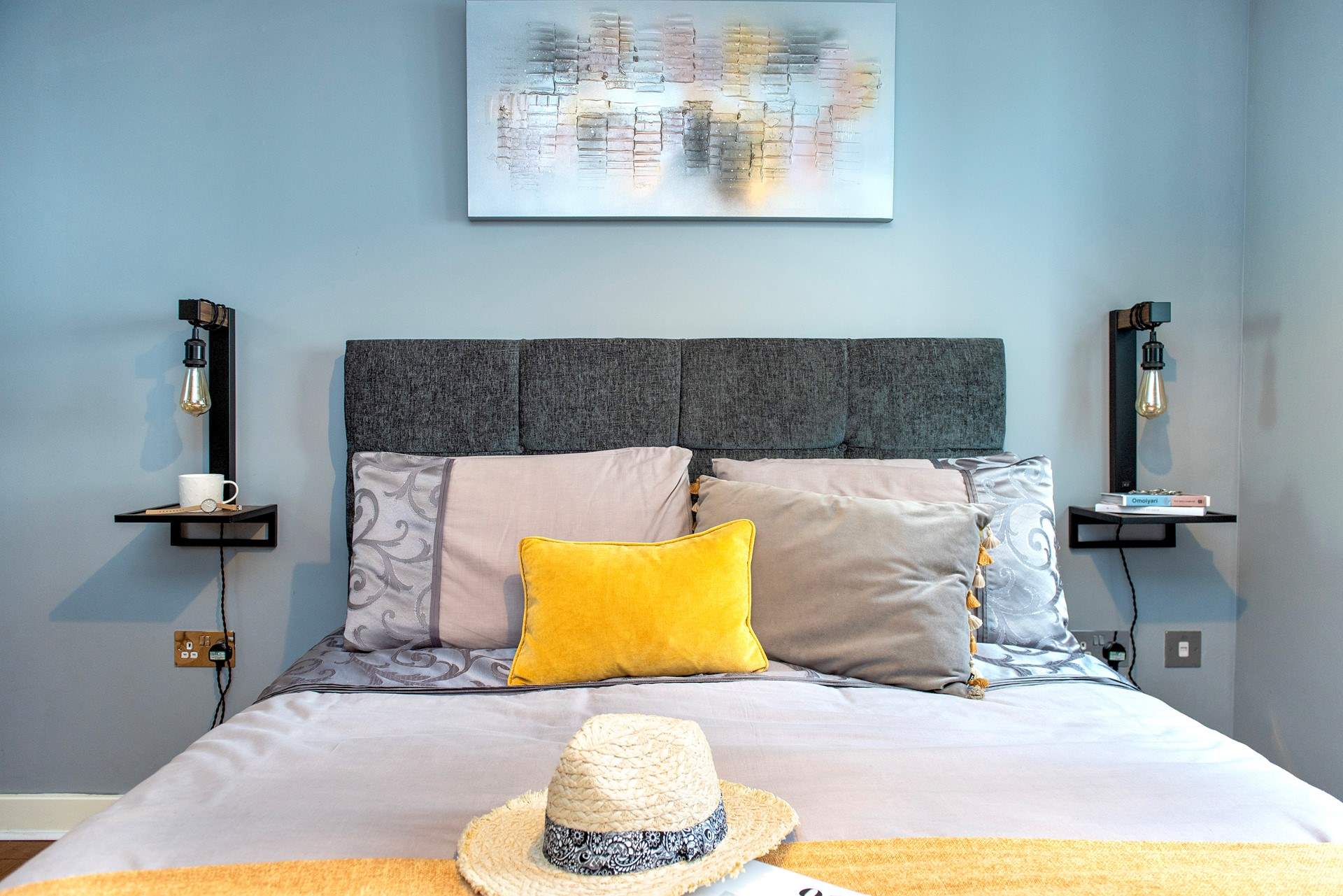 The bed is beautifully dressed, with lovely plump cushions and soft throws.