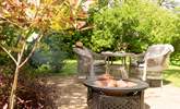 Enjoy some al fresco dining on the fire pit which doubles up as a barbecue. - Thumbnail Image