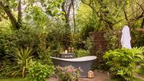 Lie back in your secluded outdoor bathtub and listen to the birdsong around you.