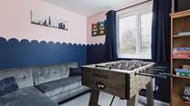 The games-room - off the sitting-room - has table-football and a TV so kids (big or small) can have some fun together.