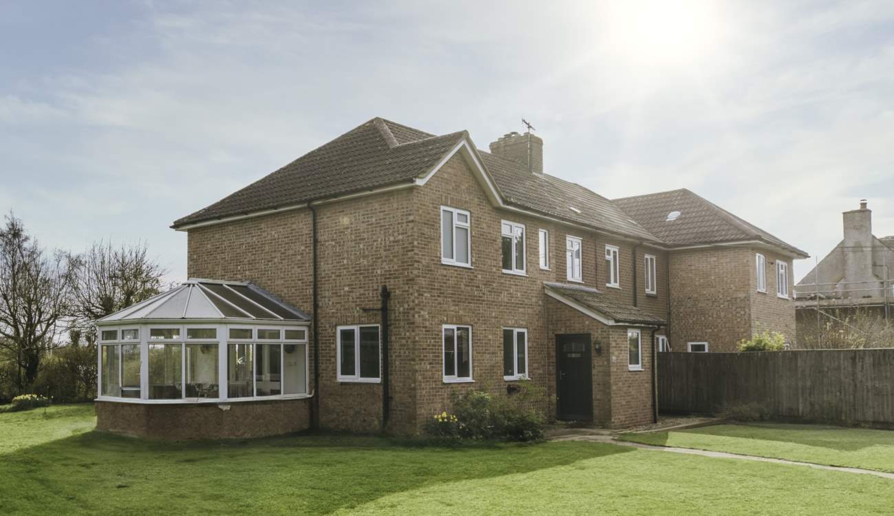 The garden wraps round the cottage.