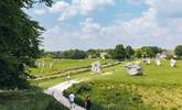 Visit Avebury and see the Neolithic henge monument containing three stone circles. - Thumbnail Image