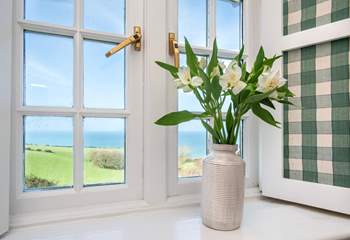 Pretty shutters frame the bedroom windows.