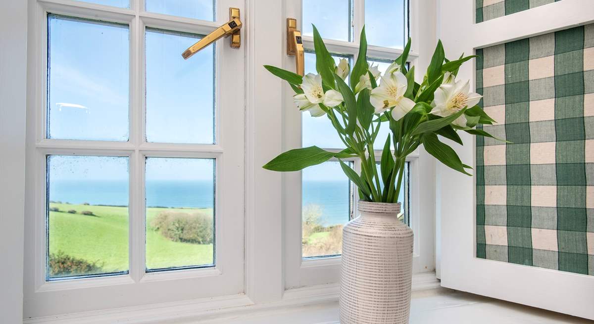 Pretty shutters frame the bedroom windows.