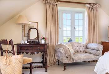 This large spacious triple aspect room,  makes the most the setting and those sublime views.