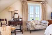 This large spacious triple aspect room,  makes the most the setting and those sublime views.