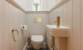 Contemporary gold fittings in the downstairs cloakroom add a delightful twist. - Thumbnail Image