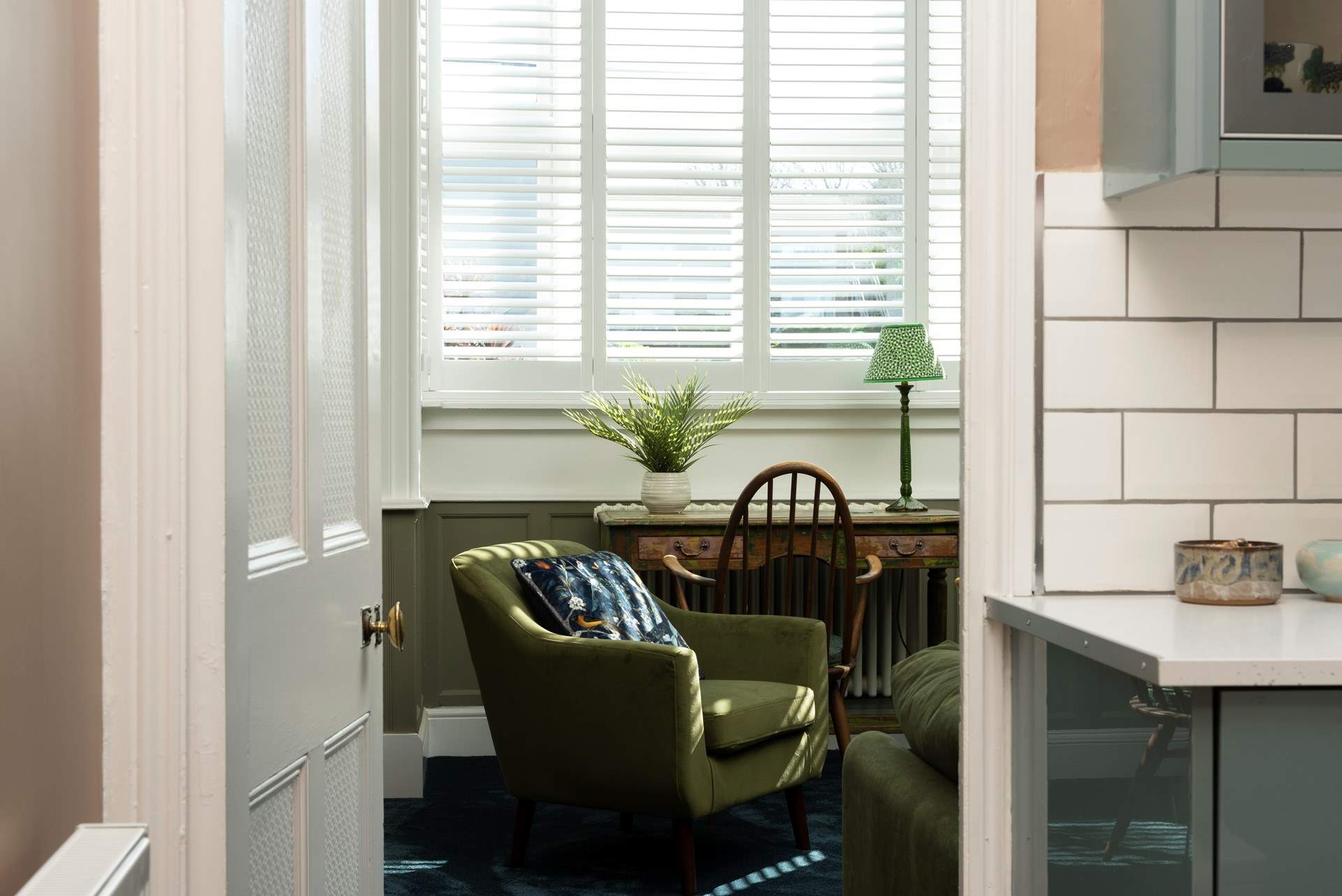 The huge bay window in the beautiful lounge throws rays of light through to the kitchen.
