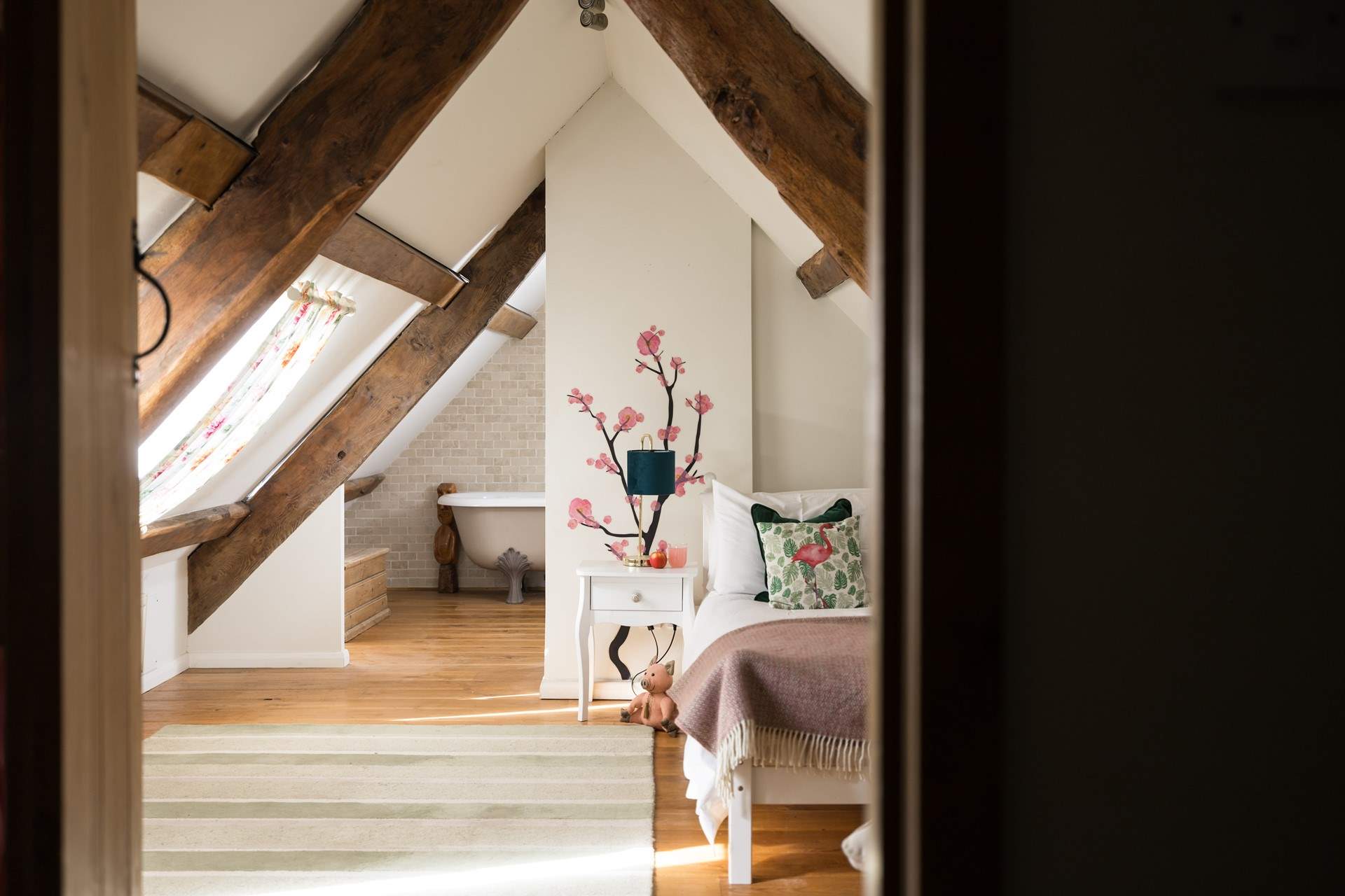 Bedroom four has a single bed and sloping ceilings and original beams