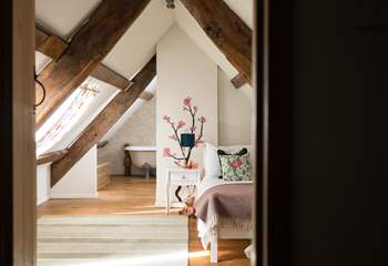 Bedroom four has a single bed and sloping ceilings and original beams