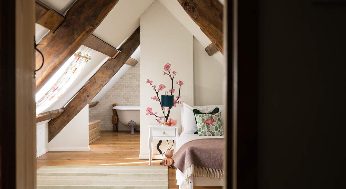 Bedroom four has a single bed and sloping ceilings and original beams