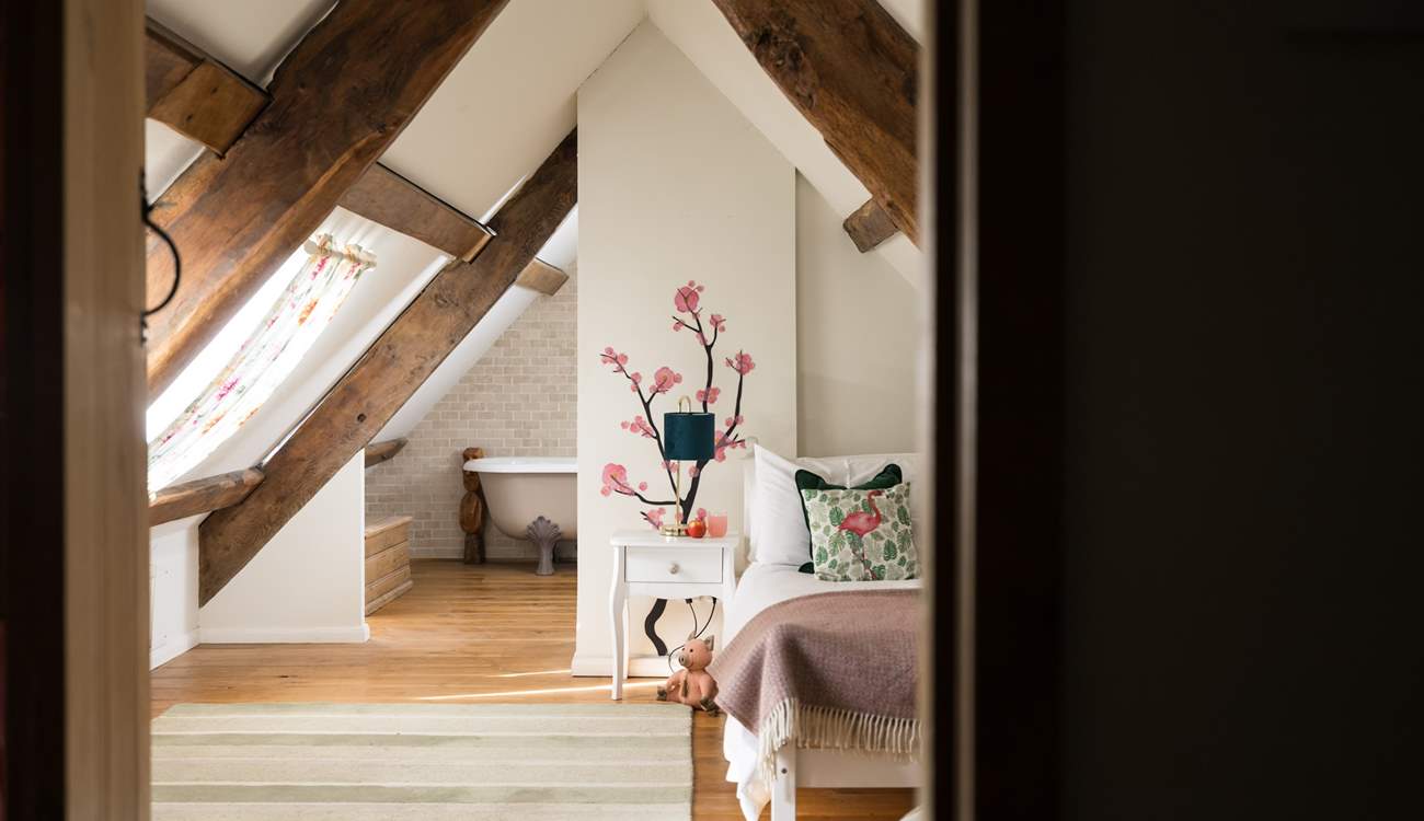 Bedroom four has a single bed and sloping ceilings and original beams