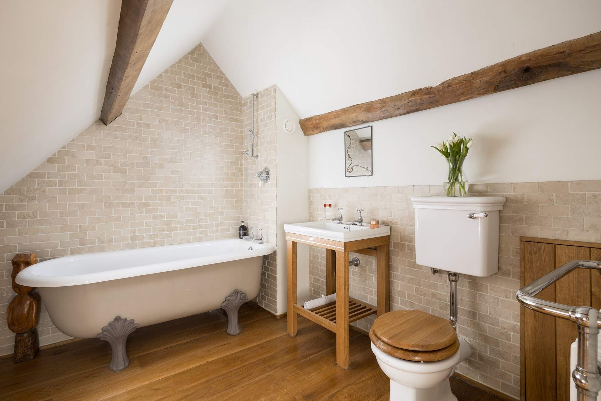 Stylish en suite bathroom to bedroom four, please note the ceiling slopes.