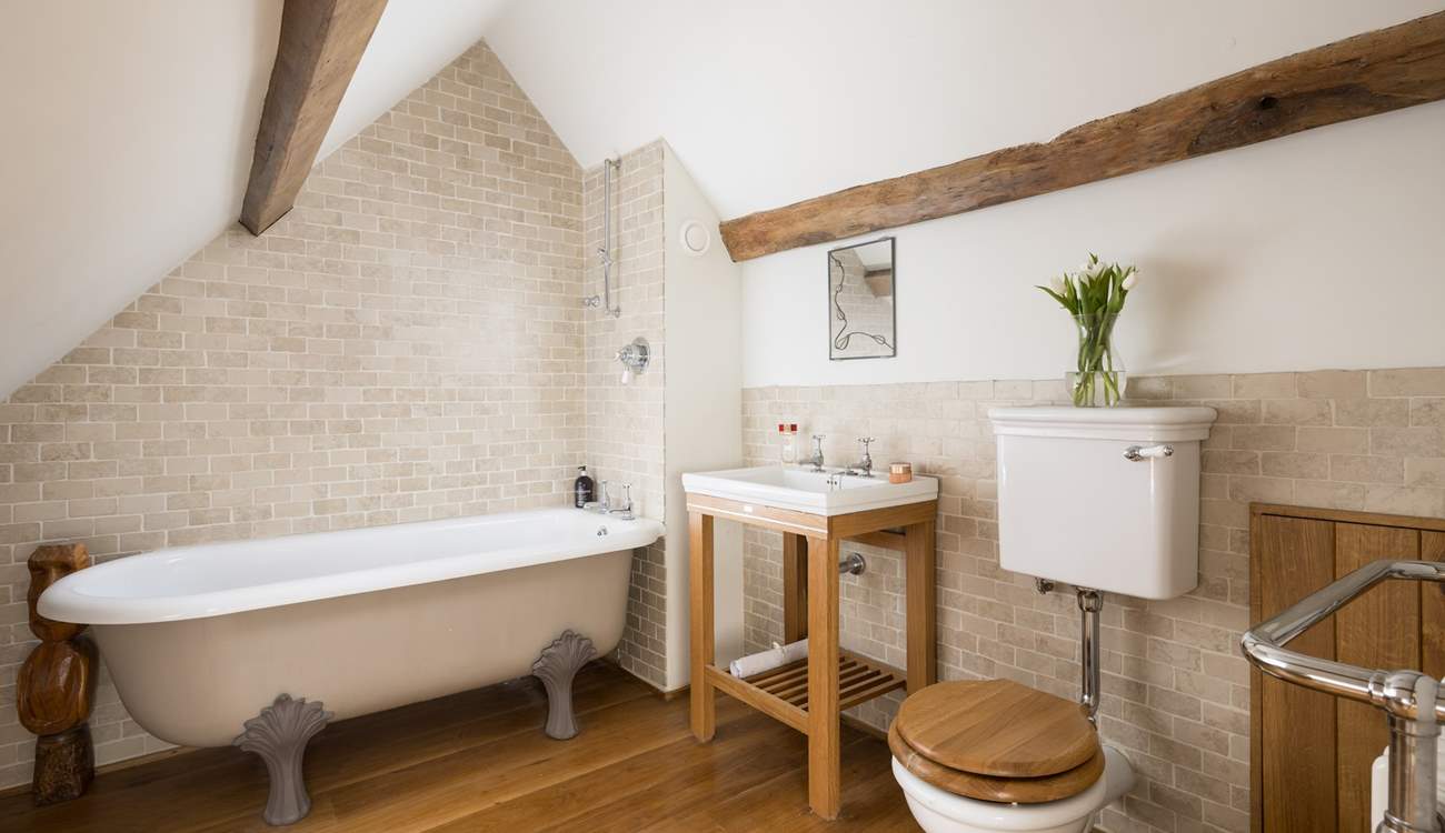 Stylish en suite bathroom to bedroom four, please note the ceiling slopes.