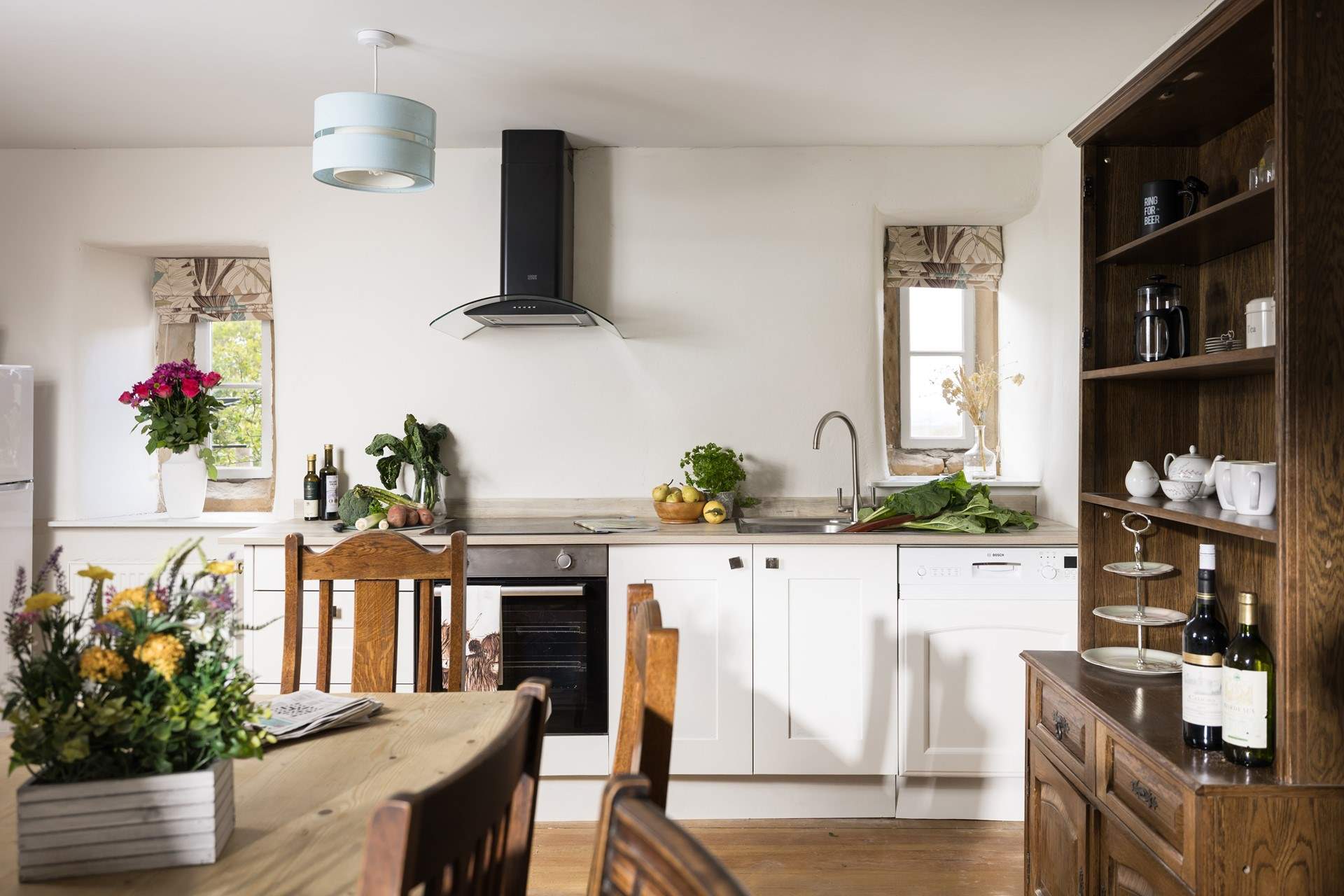 The original floor and fireplace grace the stylish kitchen.