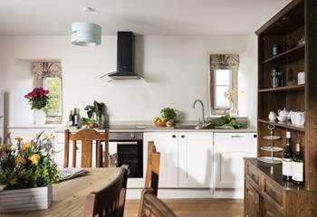 The original floor and fireplace grace the stylish kitchen.