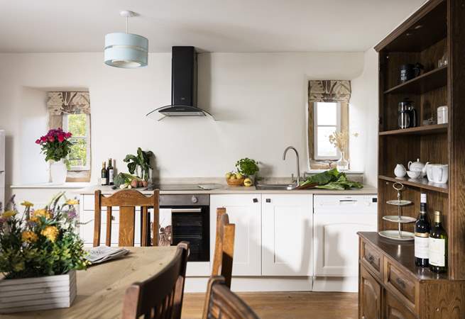 The original floor and fireplace grace the stylish kitchen.