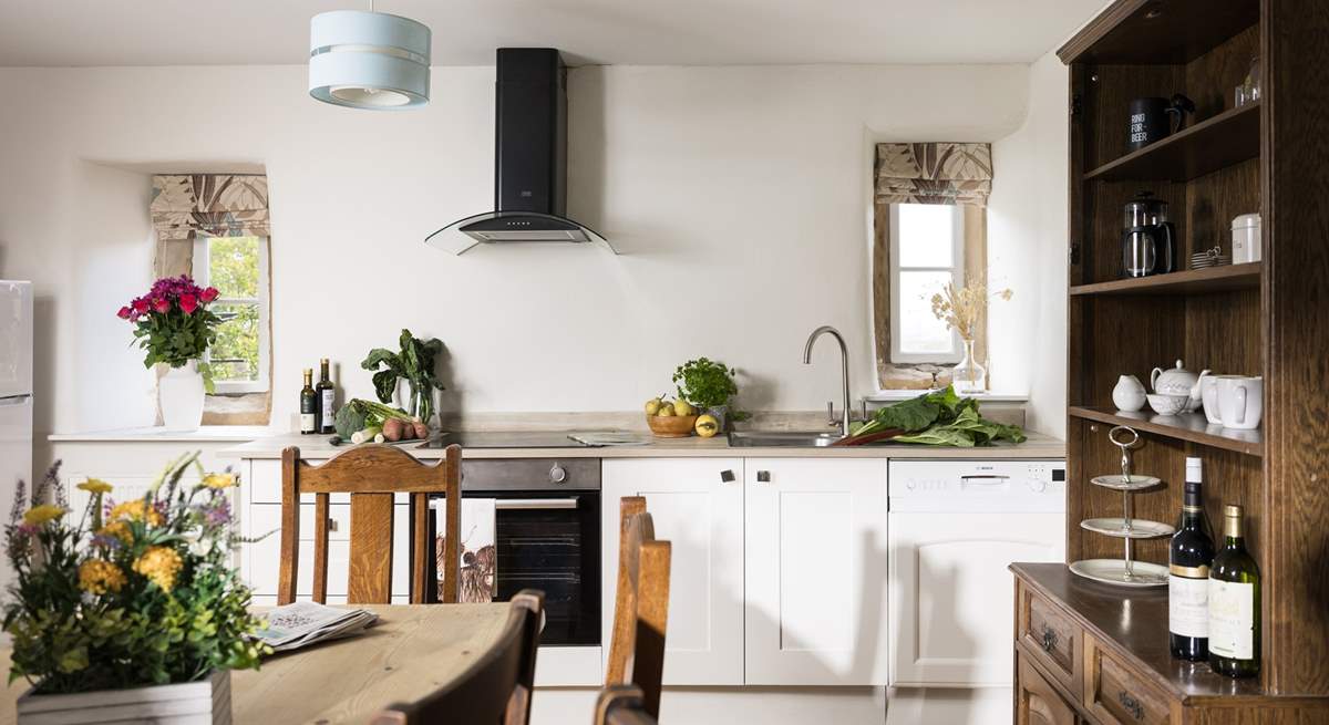 The original floor and fireplace grace the stylish kitchen.