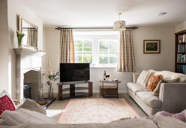 The sitting-room is light, airy and looks over the garden and countryside views.