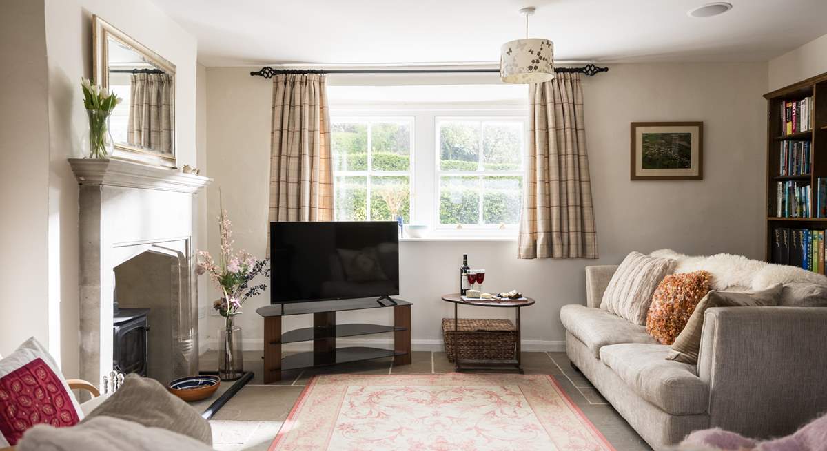 The sitting-room is light, airy and looks over the garden and countryside views.