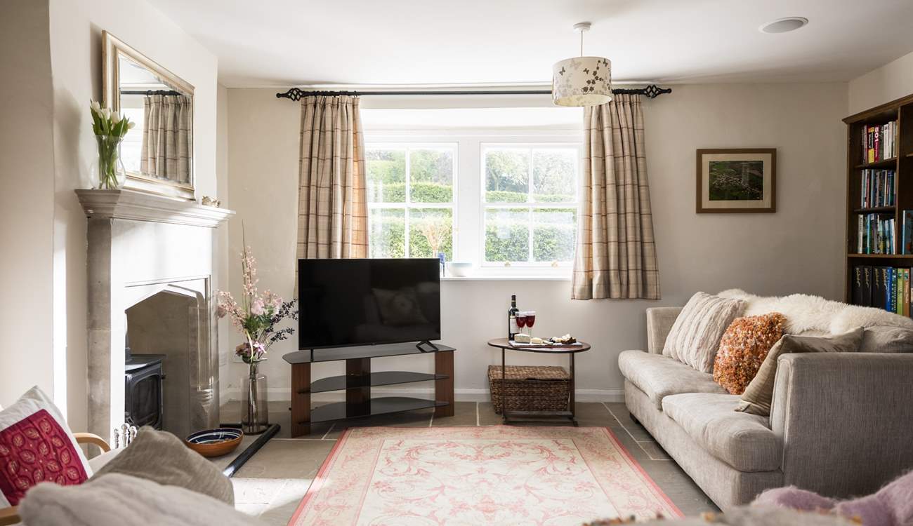 The sitting-room is light, airy and looks over the garden and countryside views.
