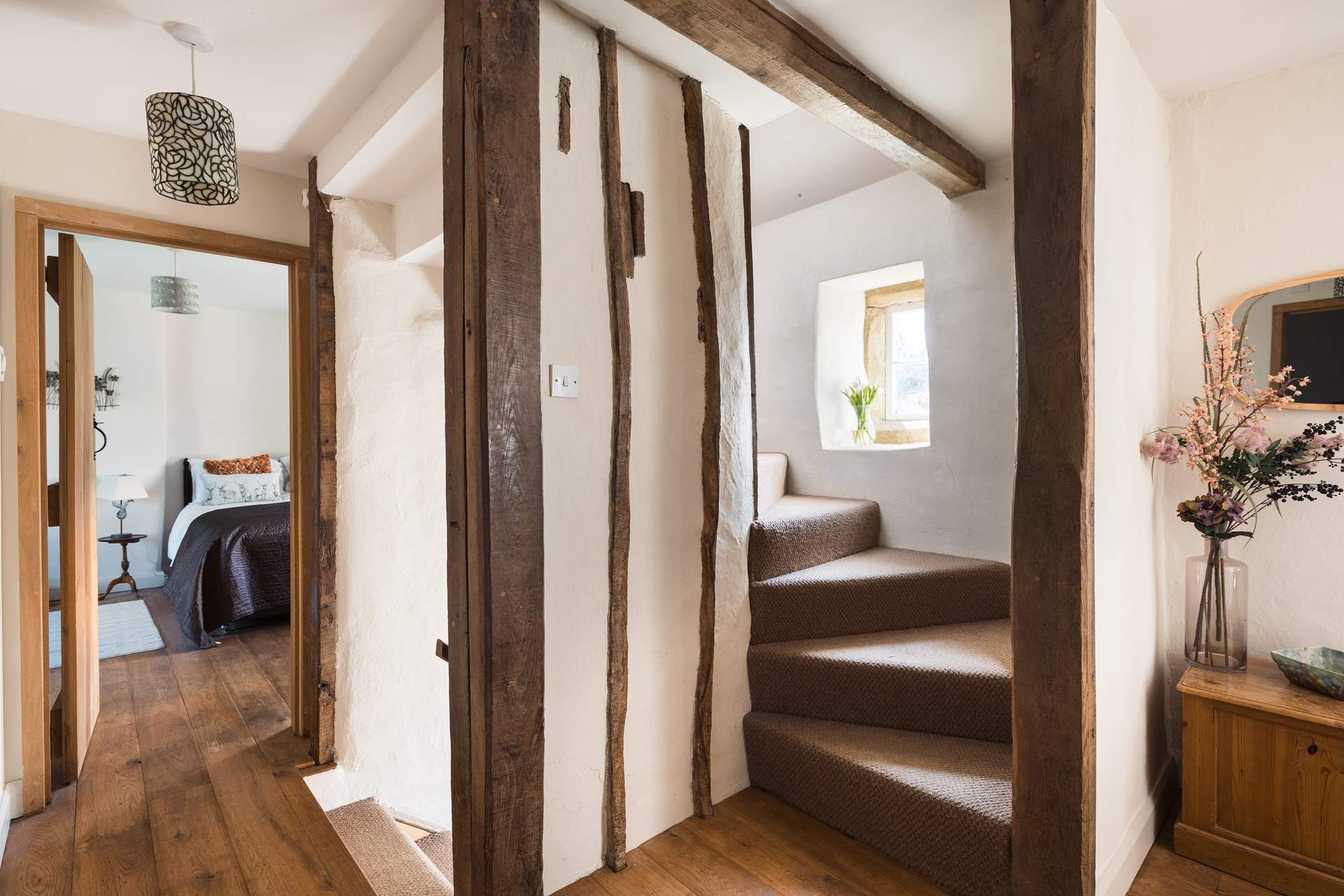 Original beams are everywhere, staircase to the second floor.