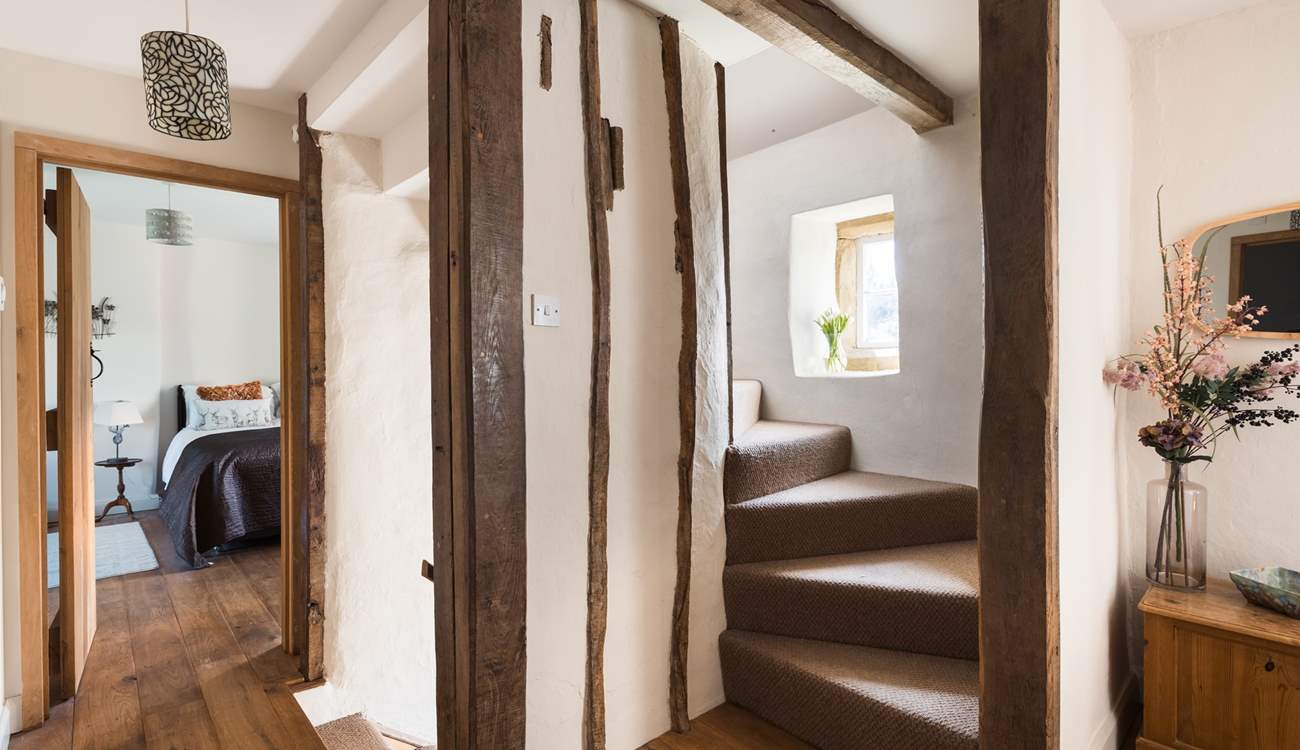 Original beams are everywhere, staircase to the second floor.