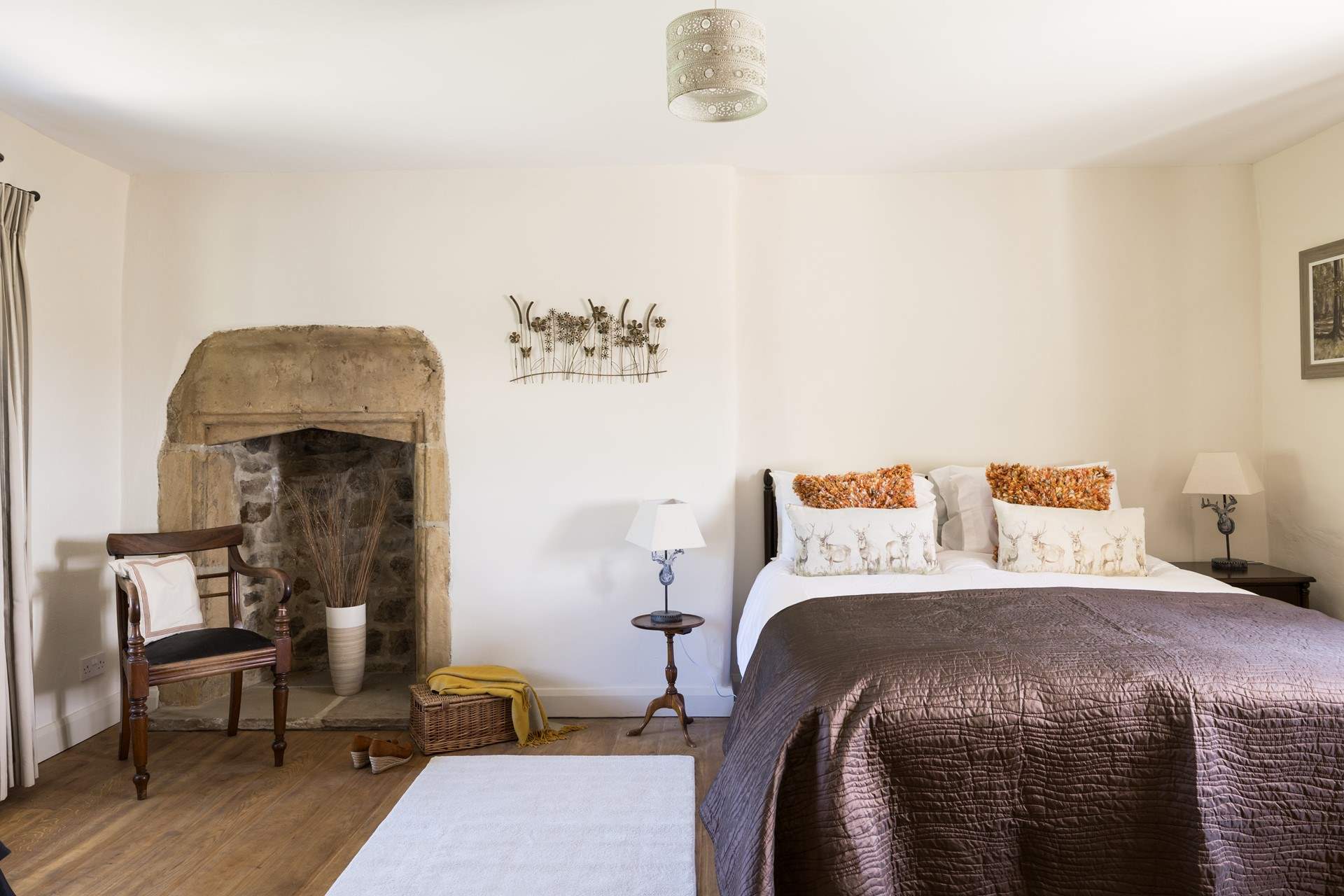 The elegant king-size bedroom with original fireplace.
