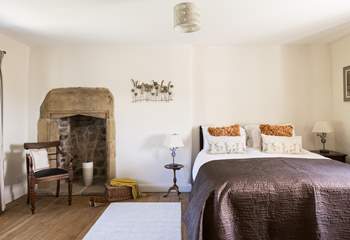 The elegant king-size bedroom with original fireplace.