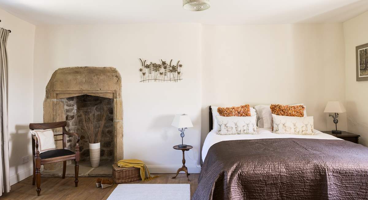 The elegant king-size bedroom with original fireplace.