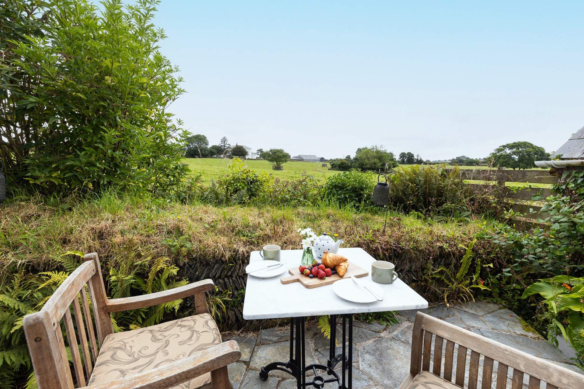 There is a small patio at the rear of the cottage that looks over rolling fields.
