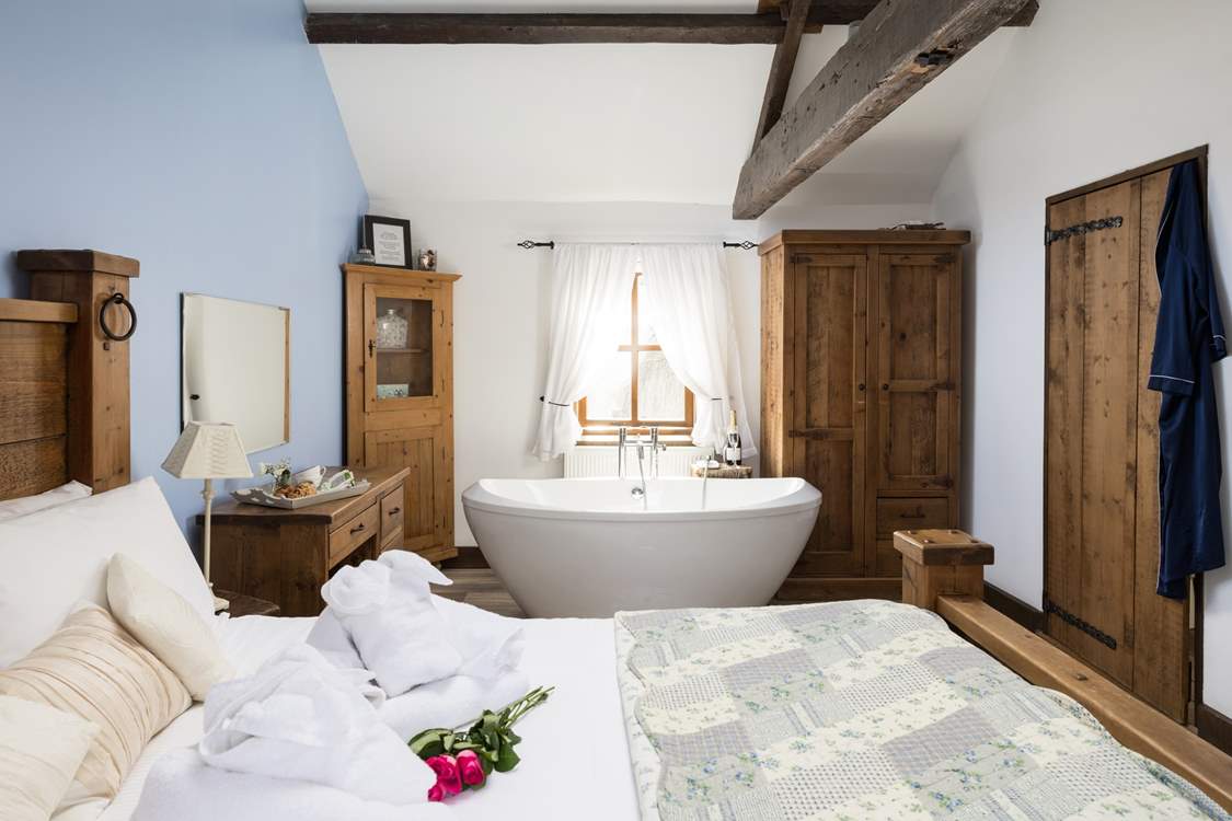 Hand-made furniture and original beams grace this delightful king-size bedroom.