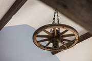 An old wheel is cleverly renovated into a chic light.