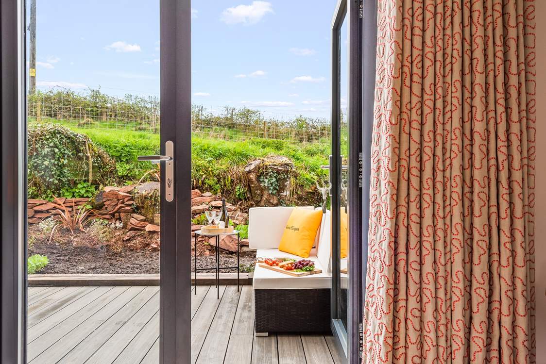 Step out of the first floor living and sleeping area onto your private sun-trap patio.