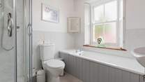 With a separate bath and shower unit, this bathroom will accommodate everyone.