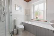 With a separate bath and shower unit, this bathroom will accommodate everyone.