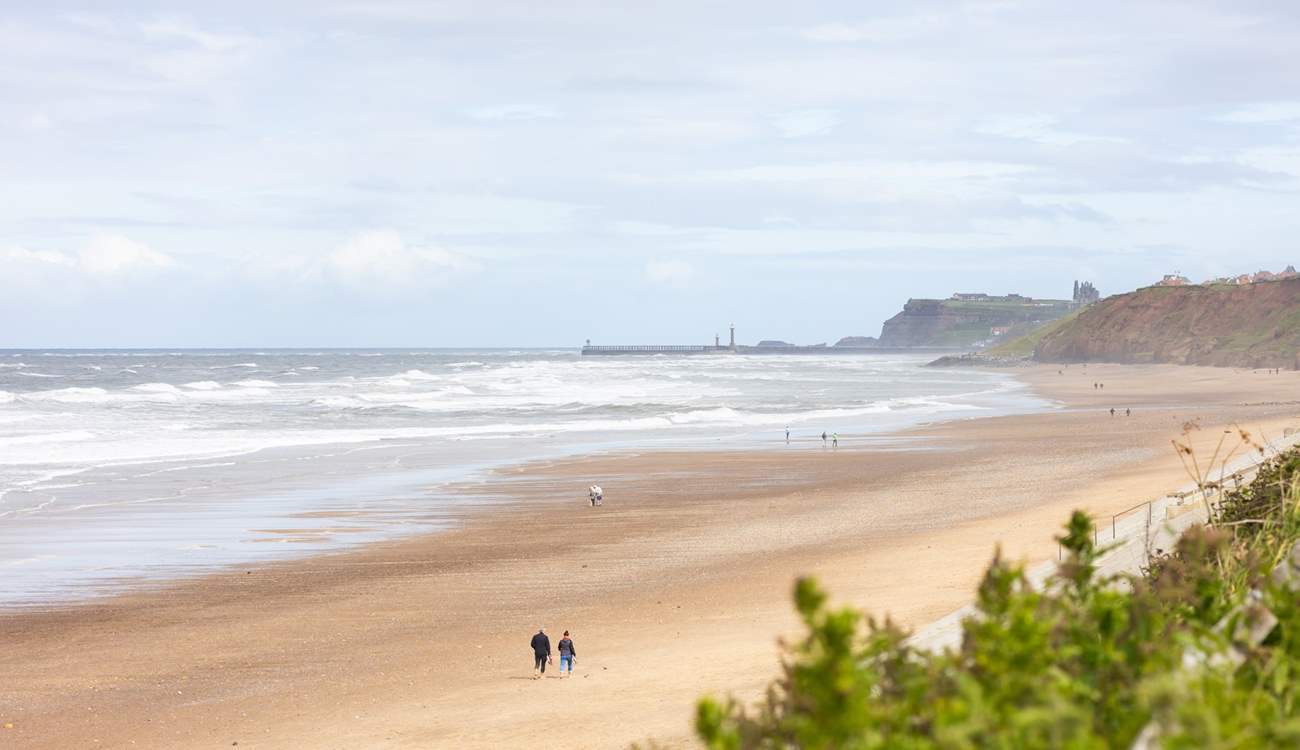 Iconic Whitby Abbey, as seen from Sandsend, sits on the cliffs looking over the town, walk along the piers or take a boat trip and look for Minke whales or dolphins.