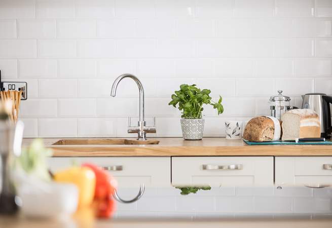 The chef will enjoy spending time in the pretty kitchen.