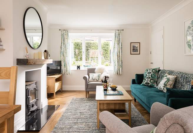 The light and airy sitting-area looks over the flower borders.