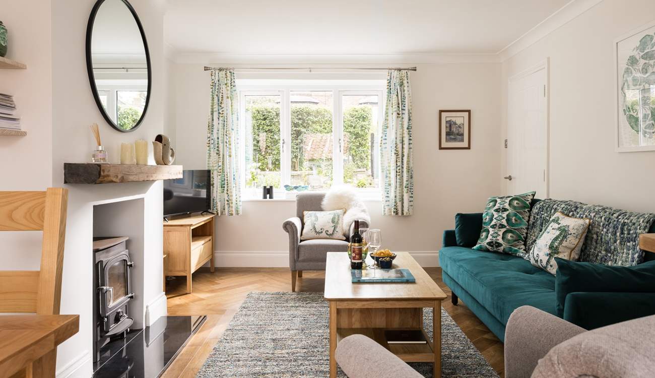The light and airy sitting-area looks over the flower borders.