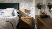 Dappled sunlight highlights the stylish design of this bedroom.