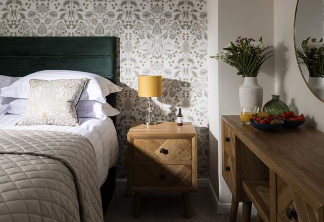 Dappled sunlight highlights the stylish design of this bedroom.