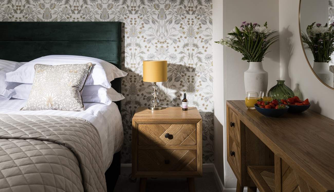 Dappled sunlight highlights the stylish design of this bedroom.