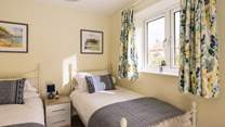 Sunny colours give the twin room a cosy feel.
