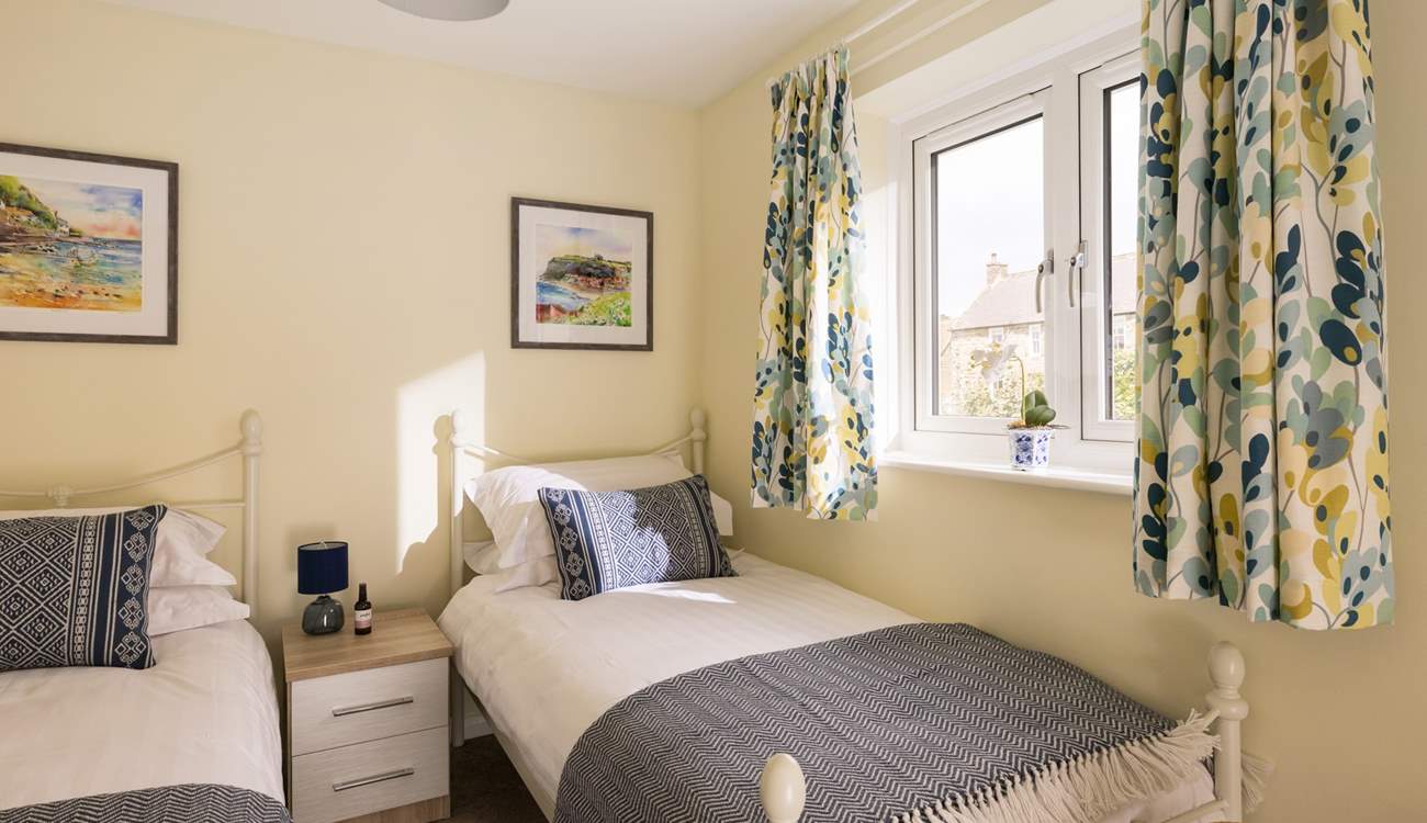 Sunny colours give the twin room a cosy feel.