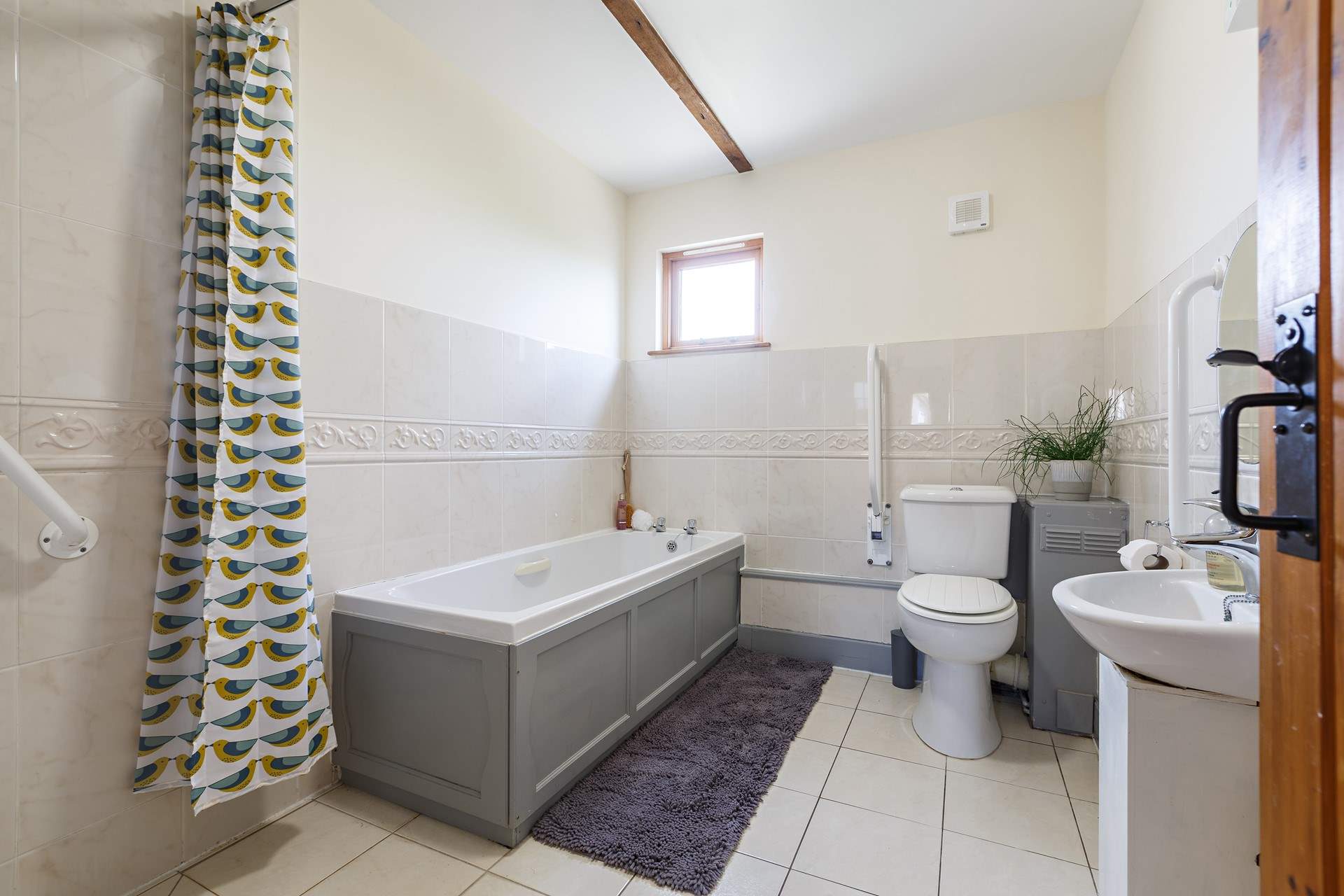 The spacious bathroom with bath and walk in shower.