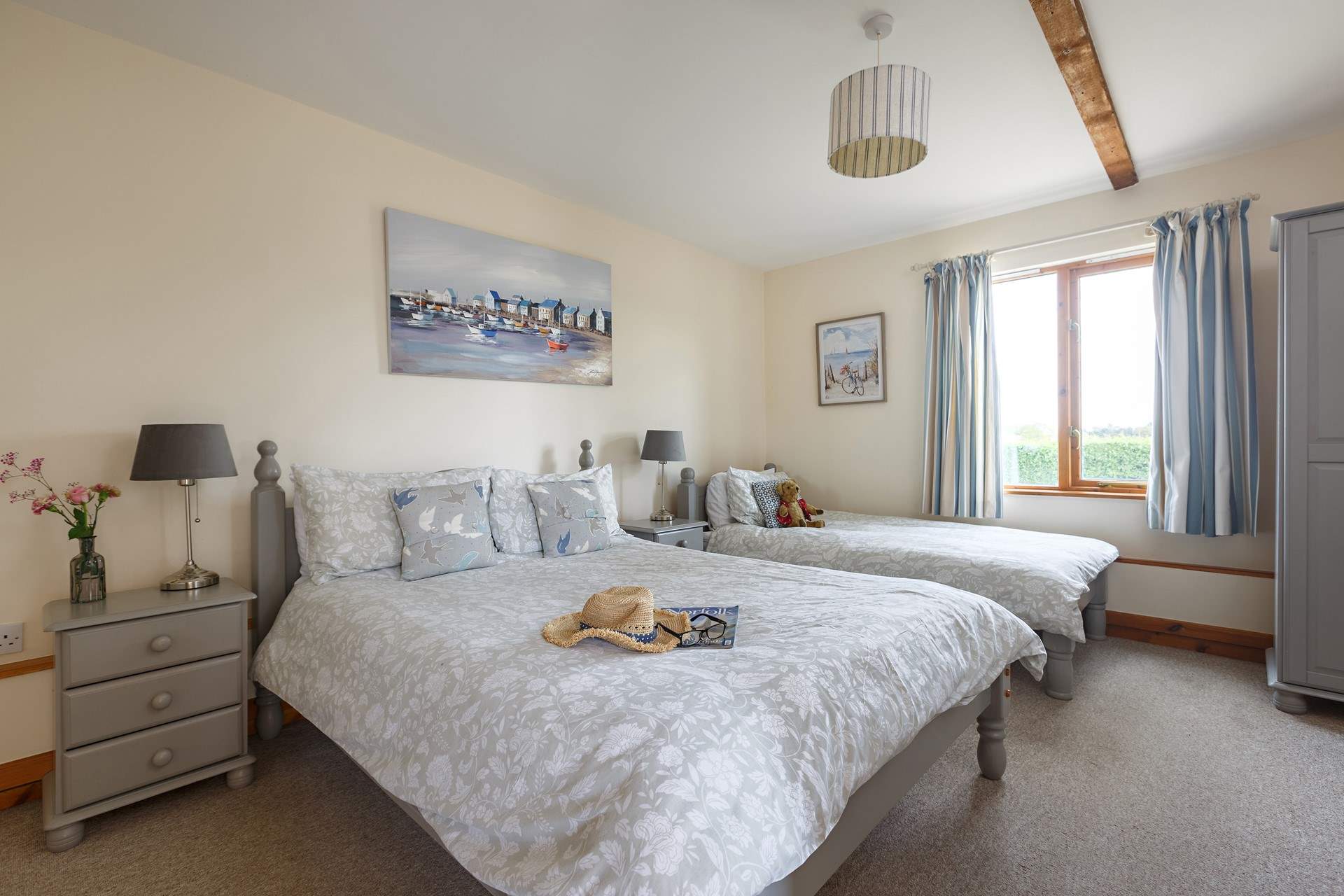 The family room with a double and single bed enjoys countryside views.